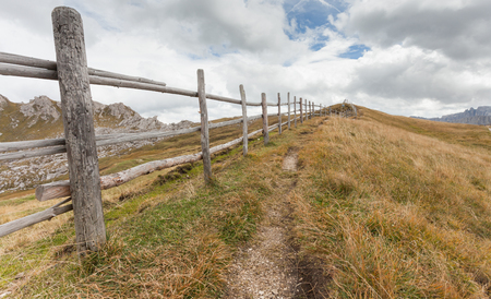 Wooden fence long a path in Val di Funesの写真素材