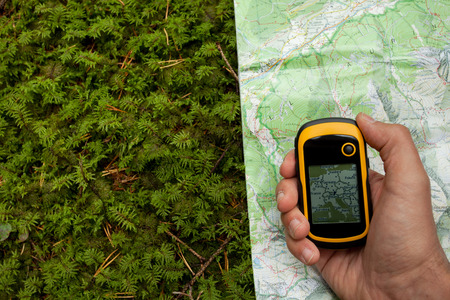 finding the right position in the forest with a map and GPSの写真素材