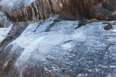 a layer of verglas or ice on rocks coul be very dangerous for climbersの写真素材