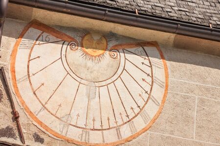VAL DI FUNES, ITALY - SEPTEMBER 29, 2016:  A detail of the old sundial painted on 1465 over the...
