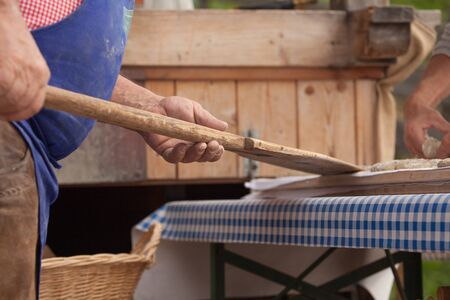 VAL DI FUNES, ITALY - OCTOBER 01, 2016: Traditional Rye flour bread cooked on site during the "Speckfest" celebration in Val di Funes, Dolomites.のeditorial素材