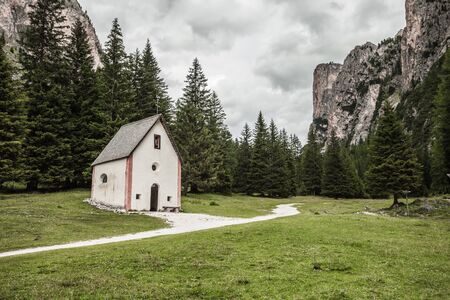 An isolated little chapel (St. Silvester) among the woods in the Italian Dolomitesの写真素材