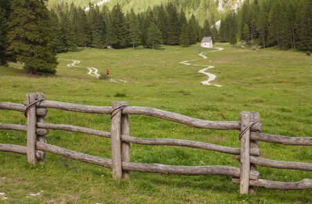 wooden fence long a mountain pasture in Val Gardenaの写真素材