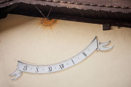 A sundial painted outside an house in Chiusa, Italy