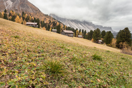 Some mountain haylofts in Dolomites with wonderful panorama at fallの写真素材