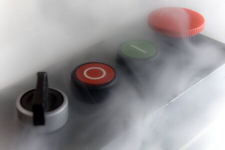 Dusty button console of an industrial machinery (including power ON/OFF and emergency stop buttons).