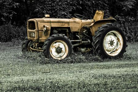 Rusty tractor abandoned in a fieldの写真素材
