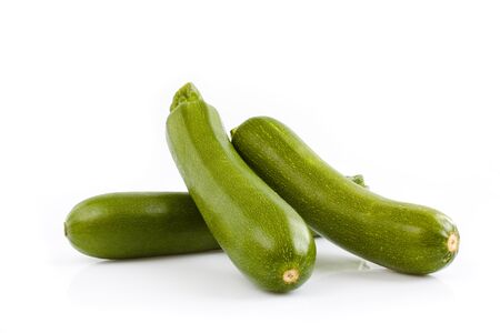 Three green zucchini isolated on white background. Still-life picture taken in studio with soft-box.の写真素材