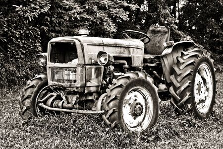 Rusty tractor abandoned in a field - Black and white imageの写真素材