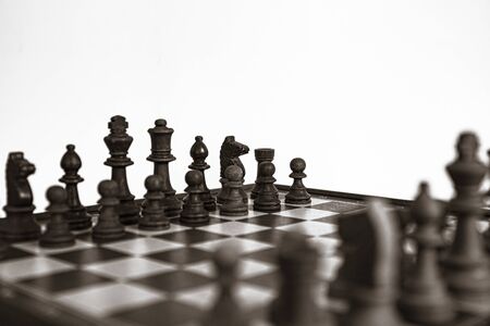 Chess pieces lined up on the chessboard. Concept picture concerning decision making and strategy. Black and white.の写真素材