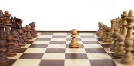 Chess pieces lined up on the chessboard with pawn moved. Concept picture concerning decision making and strategy.の写真素材