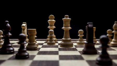 Chessboard with various pieces fighting during a game. Concept picture taken in studio and concerning decision making and strategy.の写真素材