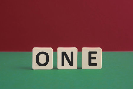 Word ONE written with leisure game tiles. Conceptual image representing a textual message communicated using letters from a board game.の写真素材