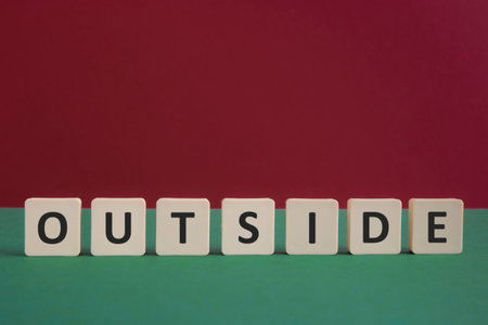 Word OUTSIDE written with leisure game tiles. Conceptual image representing a textual message communicated using letters from a board game.の写真素材
