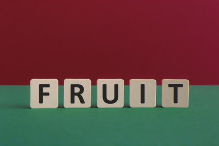 Word FRUIT written with leisure game tiles. Conceptual image representing a textual message communicated using letters from a board game.の写真素材