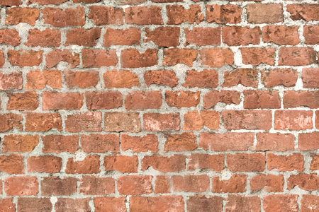 Red brick wall. Architectural seamless pattern of an ancient wall. Textured background with copy...