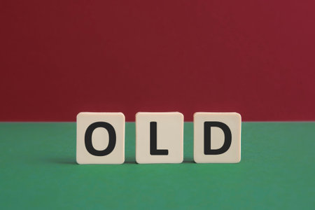 Word OLD written with leisure game tiles. Conceptual image representing a textual message communicated using letters from a board game.の写真素材
