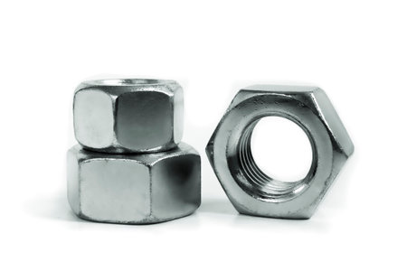 Metallic nuts. Picture taken in studio with soft-box and white background representing some mechanical components.の写真素材