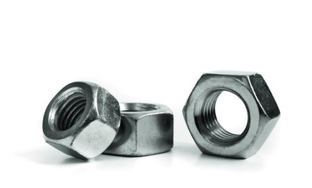 Metallic nuts. Picture taken in studio with soft-box and white background representing some mechanical components.の写真素材