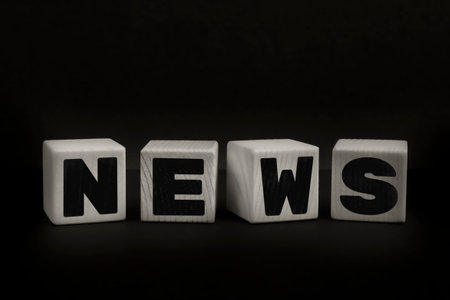 Word NEWS written with wooden cubes. Studio shot of some arranged wooden blocks with a textual message.の写真素材