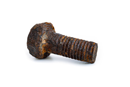 Rusty metal bolt. Mechanical component worn out by time and covered in rust isolated on white background.の写真素材