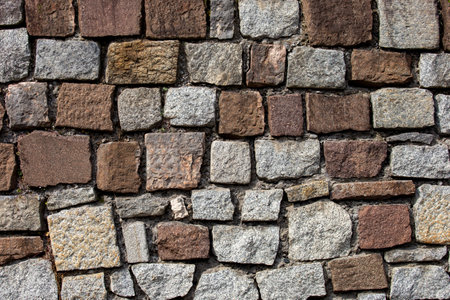 Stone brick wall. Architectural seamless pattern of an ancient wall. Textured background with copyspace.の写真素材