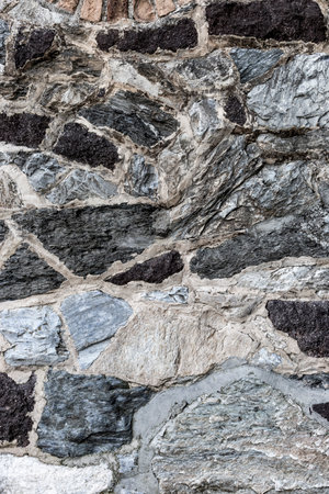 Rustic wall of cemented stones. Architectural element. Textured background with copyspace.の写真素材