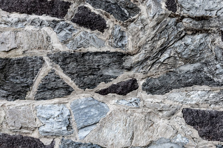 Rustic wall of cemented stones. Architectural element. Textured background with copyspace.の写真素材