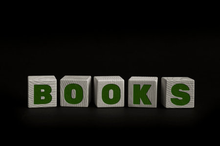 Word BOOKS written with wooden cubes. Studio shot of some arranged wooden blocks with a textual message.の写真素材