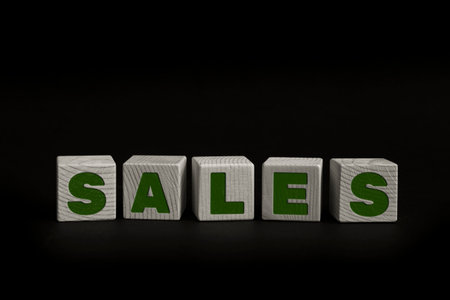 Word SALES written with wooden cubes. Studio shot of some arranged wooden blocks with a textual message.の写真素材