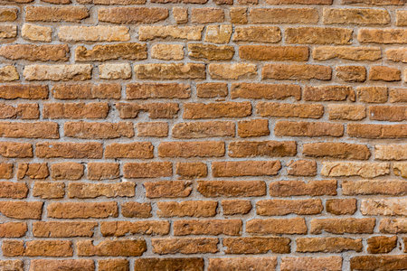 Red brick wall. Architectural seamless pattern of a rustic wall. Textured background with copyspace.の写真素材