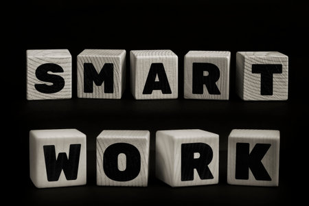 Words SMART WORK written with wooden cubes. Studio shot of some arranged wooden blocks with a textual message.の写真素材