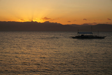 sunset over the mountains of negros from cebuの写真素材