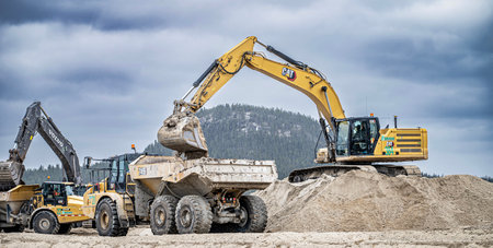 Eeyou Istchee Baie-James, Quebec, Canada, 2023-05-17, Excavator filling a dump truck with sand on a northern construction siteのeditorial素材