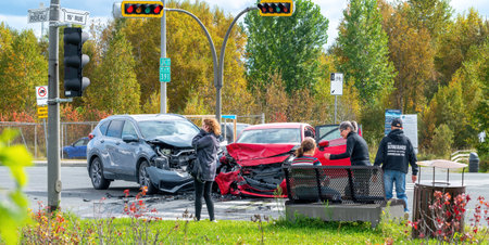 Rouyn-Noranda, Quebec, Canada, 2022-09-26, Head-to-head crash involving two vehicles at an intersection with witnesses offering first aidのeditorial素材