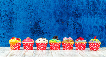 Colorful cupcakes on a wooden backgroundの写真素材