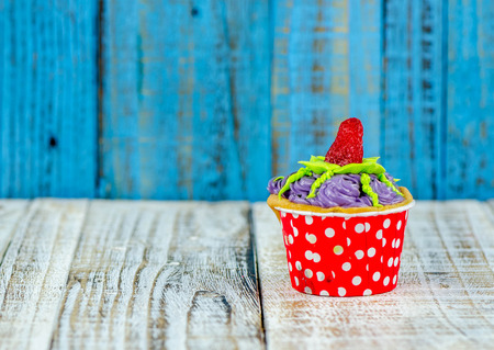 Colorful cupcakes on a wooden backgroundの写真素材
