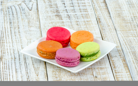 Colorful macarons on vintage pastel background. Macaron or Macaroon sweet meringue-based confection.の写真素材