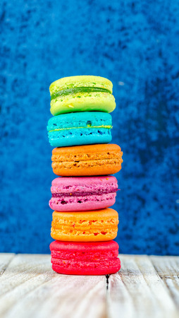 Colorful macarons on vintage pastel background. Macaron or Macaroon sweet meringue-based confection.の写真素材