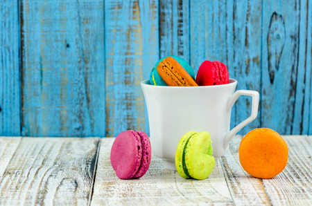 Colorful macarons on vintage pastel background. Macaron or Macaroon sweet meringue-based confection.の写真素材