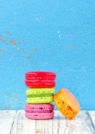 Colorful macarons on vintage pastel background. Macaron or Macaroon sweet meringue-based confection.の写真素材