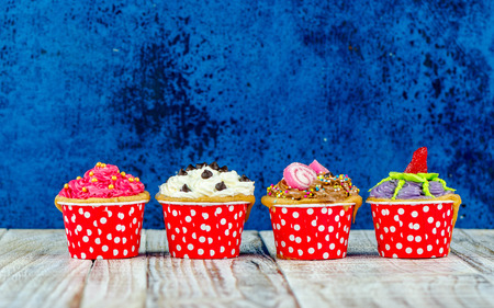 Colorful cupcakes on a wooden backgroundの写真素材