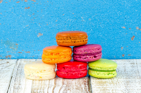 Colorful macarons on vintage pastel background. Macaron or Macaroon sweet meringue-based confection.の写真素材