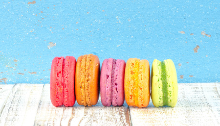 Colorful macarons on vintage pastel background. Macaron or Macaroon sweet meringue-based confection.の写真素材