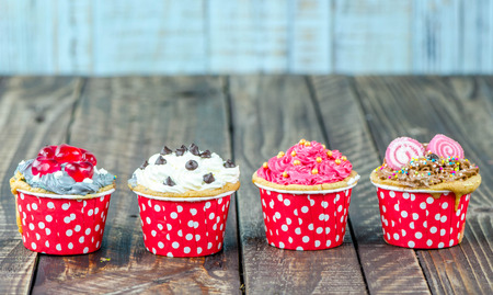 Colorful cupcakes on a wooden backgroundの写真素材