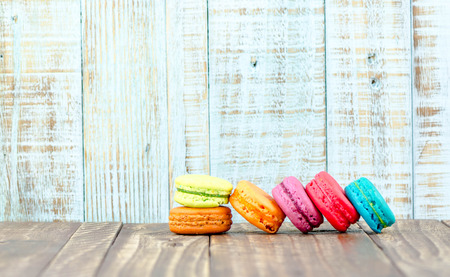 Colorful macarons on vintage pastel background. Macaron or Macaroon sweet meringue-based confection.の写真素材