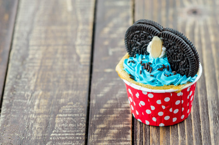 Colorful cupcakes on a wooden backgroundの写真素材