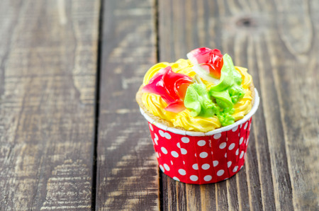 Colorful cupcakes on a wooden backgroundの写真素材