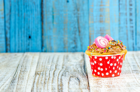 Colorful cupcakes on a wooden backgroundの写真素材