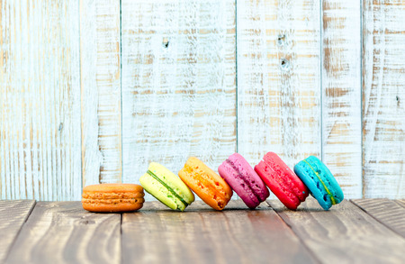 Colorful macarons on vintage pastel background. Macaron or Macaroon sweet meringue-based confection.の写真素材
